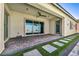 Covered patio with pavers and artificial turf provides a seamless transition to the backyard at 10062 Mountain Foothills Ave, Las Vegas, NV 89149