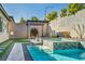 Backyard pool area with pergola, artificial turf, and landscaped garden is great for entertaining at 10062 Mountain Foothills Ave, Las Vegas, NV 89149