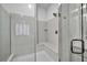 Close-up of a modern glass walk-in shower with a built-in bench and sleek fixtures at 10062 Mountain Foothills Ave, Las Vegas, NV 89149