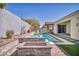 Beautiful backyard swimming pool and spa with built-in fire pit and luxurious landscaping at 10062 Mountain Foothills Ave, Las Vegas, NV 89149