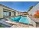 Stunning backyard swimming pool and spa surrounded by lush landscaping and luxurious patio area at 10062 Mountain Foothills Ave, Las Vegas, NV 89149