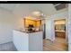 Well-lit kitchen featuring a stainless steel refrigerator and appliances with a view to the bathroom at 10245 S Maryland Pkwy # 255, Las Vegas, NV 89183