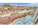 Aerial view of backyard pool and jacuzzi featuring a small park, mountain, and neighborhood views at 10368 Pima Crossing Ave, Las Vegas, NV 89166