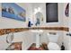 Charming powder room featuring custom wall tiles and pedestal sink at 10368 Pima Crossing Ave, Las Vegas, NV 89166