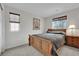 Cozy bedroom with wood-framed bed, side table, and carpeted flooring at 10368 Pima Crossing Ave, Las Vegas, NV 89166