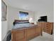 Bedroom boasts a wood-framed bed, side table, and a dresser with a television on top at 10368 Pima Crossing Ave, Las Vegas, NV 89166