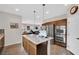 Open kitchen layout with stainless steel appliances, a kitchen island and modern lighting at 10368 Pima Crossing Ave, Las Vegas, NV 89166