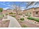 Community walking path lined with rocks, bushes, and trees at 10368 Pima Crossing Ave, Las Vegas, NV 89166