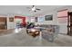 Comfortable living room with neutral tones, a ceiling fan, and windows providing natural light at 10368 Pima Crossing Ave, Las Vegas, NV 89166