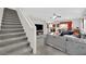 View of a open-concept living room featuring stairs, a sofa, and a dining area at 10368 Pima Crossing Ave, Las Vegas, NV 89166