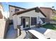 Back exterior of home with desert landscaping, turf and outdoor seating, perfect for relaxation at 10783 Vestone St, Las Vegas, NV 89141