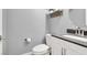 Half bath with modern toilet, vanity with storage, and neutral color scheme at 10783 Vestone St, Las Vegas, NV 89141