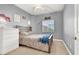 Bedroom with a queen bed, dresser, window, and decorative accents on the wall at 10783 Vestone St, Las Vegas, NV 89141