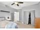 Bedroom with carpeted floors, closet with curtains, and an open doorway leading to another room at 10783 Vestone St, Las Vegas, NV 89141