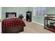 Bright bedroom with a plaid bedspread, a window, and a desk with a rolling chair at 10783 Vestone St, Las Vegas, NV 89141