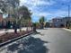 Gated community entrance with stone pillars, landscaping, and a view of the well-maintained surrounding buildings at 10783 Vestone St, Las Vegas, NV 89141