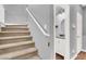 Stairway view including a half bath with a granite countertop and white cabinets at 10783 Vestone St, Las Vegas, NV 89141
