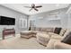 Upstairs living room featuring a large sectional sofa, wall-mounted TV, and neutral décor at 10783 Vestone St, Las Vegas, NV 89141