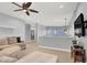 Upstairs loft-style living area with cozy seating, wall-mounted TV, and neutral color palette at 10783 Vestone St, Las Vegas, NV 89141