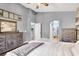 Well-lit main bedroom featuring dual dressers, an open en suite, and a comfortable bed at 10783 Vestone St, Las Vegas, NV 89141