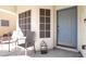 Inviting front porch featuring two chairs and a modern lantern at 10783 Vestone St, Las Vegas, NV 89141
