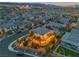 Expansive aerial view of a residential neighborhood showcasing a well-lit backyard with string lights and landscaping at 10988 Wonder Hills St, Las Vegas, NV 89141