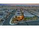 Beautiful home with a well-manicured backyard and patio area, ideal for outdoor gatherings and relaxation, at dusk at 10988 Wonder Hills St, Las Vegas, NV 89141