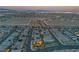 Expansive aerial view of a residential community with neatly arranged homes and streets at dusk at 10988 Wonder Hills St, Las Vegas, NV 89141