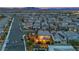Aerial view of suburban street, showcasing homes with solar panels and inviting backyard with outdoor lighting at 10988 Wonder Hills St, Las Vegas, NV 89141