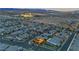 Stunning aerial view of a neighborhood with well-maintained homes and landscaping at dusk at 10988 Wonder Hills St, Las Vegas, NV 89141