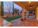 Back patio featuring a built-in bar, ceiling fan, manicured lawn, and landscaping at 10988 Wonder Hills St, Las Vegas, NV 89141