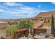Backyard featuring seating areas, mature trees, desert landscaping, and mountain views at 10988 Wonder Hills St, Las Vegas, NV 89141
