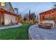 Beautiful backyard with fire pit, pergola, lawn, and outdoor movie screen at 10988 Wonder Hills St, Las Vegas, NV 89141