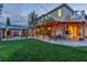 Spacious backyard with manicured lawn, gazebo, fire pit, mature trees, and covered patio at 10988 Wonder Hills St, Las Vegas, NV 89141