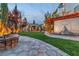 A relaxing outdoor space is captured with a stone fire pit and pergola movie screen, perfect for entertainment at 10988 Wonder Hills St, Las Vegas, NV 89141