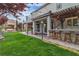 Expansive backyard featuring lush lawn, outdoor kitchen, bar, and covered patio perfect for entertaining at 10988 Wonder Hills St, Las Vegas, NV 89141