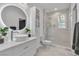 Modern bathroom with a vessel sink, sleek cabinets, and a glass-enclosed shower providing a luxurious experience at 10988 Wonder Hills St, Las Vegas, NV 89141