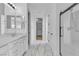 Bathroom featuring double sink vanity, walk-in shower, and storage at 10988 Wonder Hills St, Las Vegas, NV 89141
