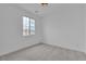 Bright bedroom features a window and plush carpeting at 10988 Wonder Hills St, Las Vegas, NV 89141