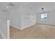 Bright bonus room with laminate flooring, floating shelves, and lots of sunlight at 10988 Wonder Hills St, Las Vegas, NV 89141