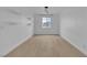 Spacious bonus room featuring laminate flooring, floating shelves, and window view at 10988 Wonder Hills St, Las Vegas, NV 89141