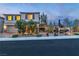 Charming two-story home featuring manicured desert landscaping with statues and outdoor lighting at 10988 Wonder Hills St, Las Vegas, NV 89141