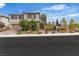 Charming two-story home featuring manicured desert landscaping with statues in the front yard at 10988 Wonder Hills St, Las Vegas, NV 89141