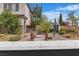 Charming two-story home featuring a well-manicured lawn with statues and decorative landscaping at 10988 Wonder Hills St, Las Vegas, NV 89141