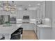 Bright kitchen with marble countertops, stainless steel appliances, and stylish pendant lighting above the island at 10988 Wonder Hills St, Las Vegas, NV 89141