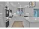 Modern kitchen featuring stainless steel appliances, marble countertops, and a center island with barstools at 10988 Wonder Hills St, Las Vegas, NV 89141