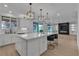 Bright kitchen with a view to the backyard, stainless steel appliances, and a spacious island with bar seating at 10988 Wonder Hills St, Las Vegas, NV 89141