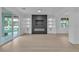 Open-concept living room featuring fireplace, built-in shelving, and seamless indoor-outdoor flow at 10988 Wonder Hills St, Las Vegas, NV 89141