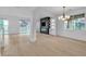 Bright and open living area with contemporary fireplace and access to outdoor spaces at 10988 Wonder Hills St, Las Vegas, NV 89141