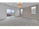 Spacious main bedroom featuring stylish wallpaper and balcony access at 10988 Wonder Hills St, Las Vegas, NV 89141